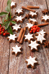 gingerbread cookie with spices on wood background