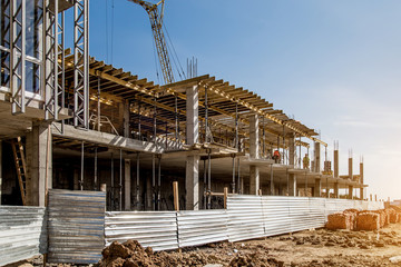 Construction site background. Hoisting cranes and new multi-storey buildings. I.ndustrial...