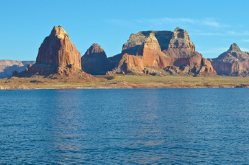 The wide golden landscape of the cool calm lake powell at dusk. 