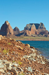 The lone shore of the wide red rock lake powell landscape in summer. 