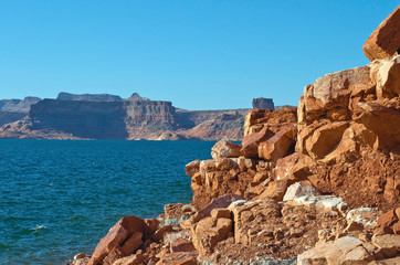 The rocky red rock shores and canyon cliffs in lake powell. 