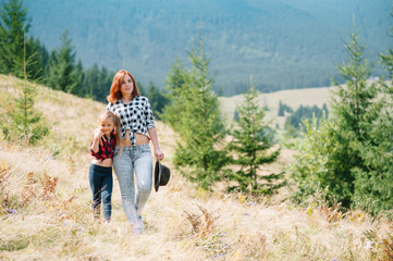 Mom hugs a little son at the top of the mountain. Square. The concept of family, yoga, travel.