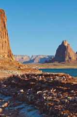 A long view of the orange and red landscape in the dusk sun on Lake Powell. 
