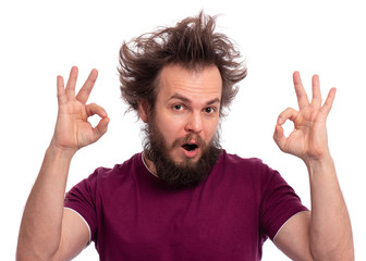 Portrait of handsome bearded man making Ok Gesture, isolated on white background. Happy crazy male smiling and giving OK sign. Caucasian man with funny haircut showing okay.