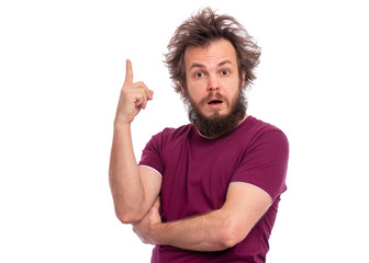Portrait of surprised bearded man pointing a great idea, isolated on white background. Awesome idea. Crazy male keeping finger up and looking at camera. Man with funny haircut have unexpected idea.