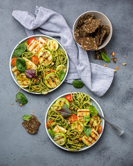 Green pasta with grilled cheese, grilled zucchini, nuts and herbs. Vegetarian perfect lunch