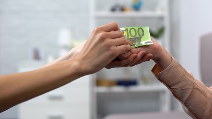 Woman putting euro banknote elderly hand, charity foundation, hospice donation