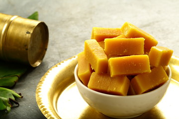 Milk ,kesar peda, burfi,  served in ceramic bowl