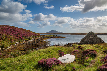Loch Langass and surrounding countryside, with an old upturned boat and derelict building in the...