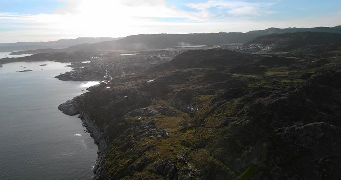 Aerial: Scenic Town Among Rocky Hills by the Ocean on a Sunny Day, Disko Bay, Greenland