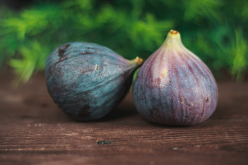 Obraz premium Fig fruits. Still life of figs on a dark wooden table.