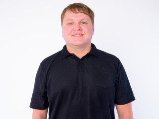 Portrait of happy overweight man smiling and looking at camera