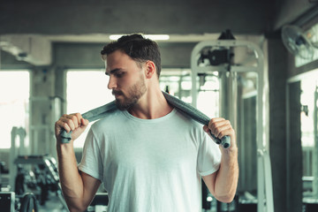 Handsome Healthy Man Holding Sweating Towel Exercised in Fitness Sport Club. Portrait of Strong Man Doing Exercising in Gym. Sport Leisure Activities and Fitness Lifestyle Concept
