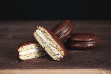Chocolate chip cookies on a dark wooden table. Cookies cut in half. Background image. Tasty...