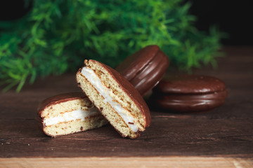 Chocolate chip cookies on a dark wooden table. Cookies cut in half. Background image. Tasty breakfast.