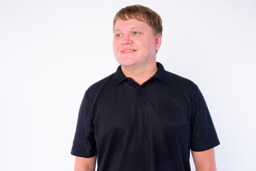 Obraz premium Portrait of happy overweight man thinking and looking up