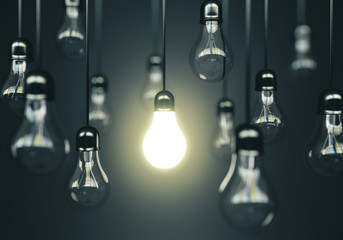 Many light bulbs and one glows