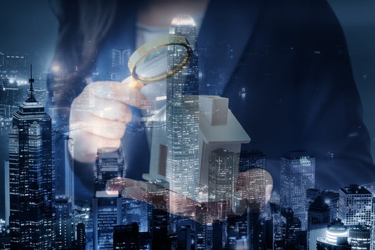 Business Real Estate and Residential Investment Concept, Broker Sell Agency of Property Estates Investigation By Magnifying Glass for Searching New Housing on Cityscape Background. Double Exposure