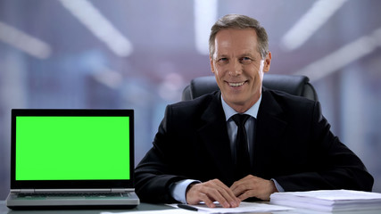 Green screen laptop near smiling man in suit business application recommendation
