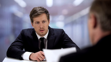 Upset office worker listening boss, mistakes made in annual report, bad result