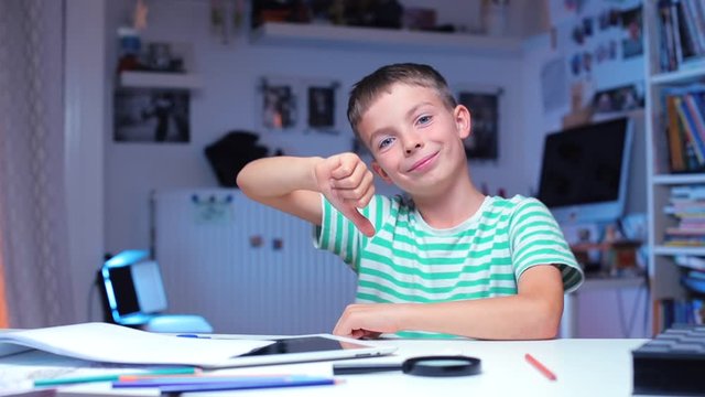 the boy shows like and dislike, begins to write a school assignment