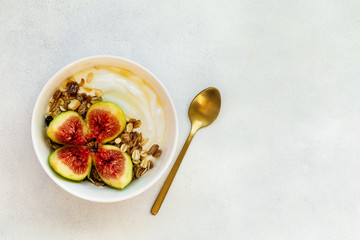 Breakfast with muesli, yogurt, figs in a bowl