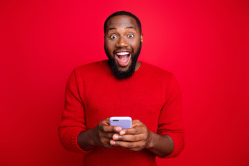 Close-up portrait of his he nice attractive cheerful cheery excited glad bearded guy using wireless...