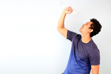 Attractive handsome asian man gets thirsty because of hot weather in the summer season on White background With copy space.