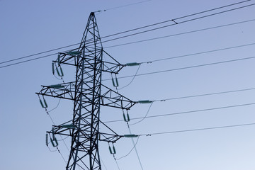 High voltage electricity transfer lines and pylon in a fog