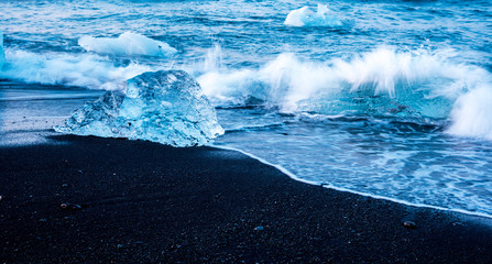 magical charming beautiful landscape with a piece of ice like a sculpture on the Diamond beach near glacier lagoon Jokulsarlon, Iceland. Exotic countries. Amazing places.