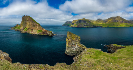 Fototapeta premium Amazing panorama with Tindholmur vertical cliff and coastline, Faroe Islands