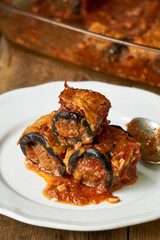 Eggplant rolls with minced meat and cheese in tomato sauce
