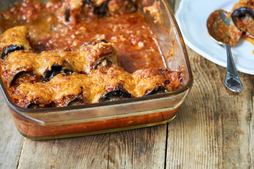 Eggplant rolls with minced meat and cheese in tomato sauce