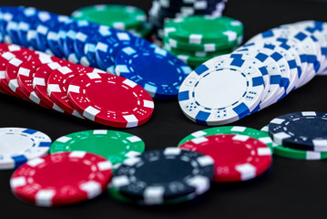 Poker chips close up on black background