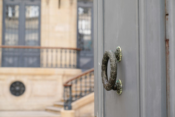 Entrance wood door and knocker of Bordeaux French private mansion house