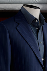 Details of bespoke striped jacket with navy blue shirt. Close-up	