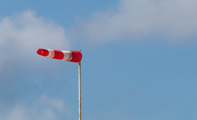 A red-white sleeve indicating the wind.