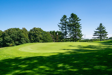 View of Golf Course with beautiful putting green. Golf course with a rich green turf beautiful scenery.