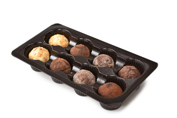 Chocolate candy collection in plastic box.