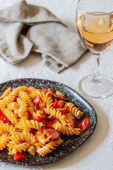 Italian pasta with vegetables and sausage. White background. National Cuisine.