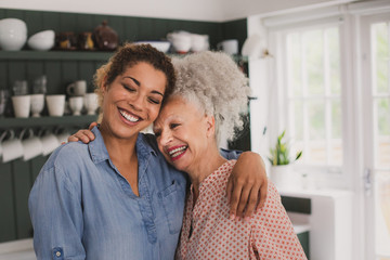 Senior adult woman hugging daughter