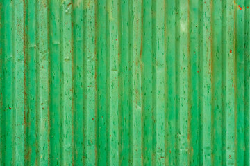 Green corrugated shipping container back. Old shipping container background texture.