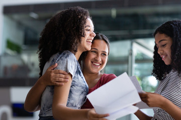 Female High school students opening their exam results