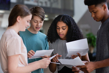 High school students opening their exam results