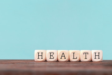 Health word written in wooden cube on wooden table , Healthcare and medical Insurance concept
