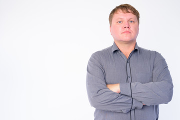 Portrait of overweight businessman with arms crossed