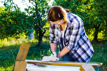 Crafts woman drawing mark on wooden plank