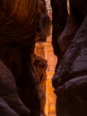 Front facade of the treasury temple of Petra, Jordan, seen from dark sandstone cliffs