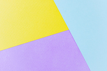 Texture paper yellow, lilac and blue. Background image. Minimalism, flat lay, place for text.