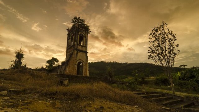 Timelapse ruin historical church in the evening with golden cloud as background at Church of the Sacred Heart of Jesus, Pagar Tras, Sungai Lembu, Penang